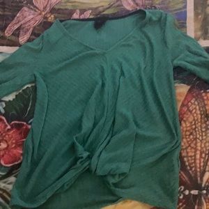 This is a small green long sleeved shirt.